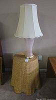 Full view of lamp on wicker stand