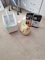 Wicker basket, fabric chicken doorstop, two boxed Space Bag sets side by side
