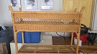 Light tan wicker shelf stand two tiers visible