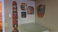 Group view showing totem and four masks on wall