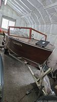 Bow and starboard view of Grenell mahogany runabout on trailer