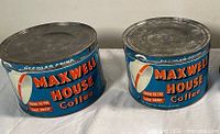 Front view of both Maxwell House Coffee tins with lids on