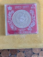 Front of cased souvenir medal showing 1952-1977 Silver Jubilee text