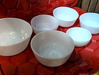 All six white milk glass bowls displayed to show sizes