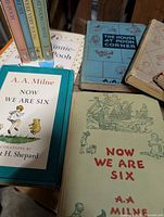 Group showing multiple A.A. Milne titles including Now We Are Six, The House at Pooh Corner and boxed Pooh’s Library set