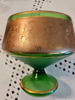 Emerald green pedestal bowl close view of gold etched band and foot