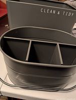 Grey oval three-compartment Clean & Tidy caddy in front of rectangular bin