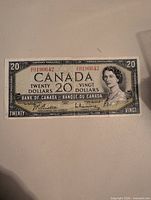 Full front view of the 1954 $20 Canadian banknote showing serial number and portrait