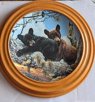 Front view of plate showing bear cub artwork in oak frame