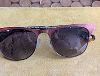 Front view of Kenzo KZ3176 sunglasses showing pink textured browline frame and dark lenses