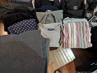 Folded garments showing variety of tops and sweaters