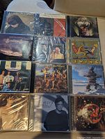 First group of sealed CDs laid out 3 × 4 showing titles and shrink-wrap