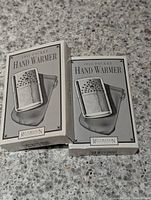 Two boxed 1955 Pocket Hand Warmers from Restoration Hardware