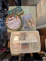 Group shot showing metal tins, plastic box and foam pad