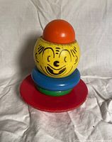 Stacking clown toy assembled showing painted face and coloured rings