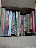 Top-down view of packed box showing most spines, mix of large hardcovers and smaller Beginner Books