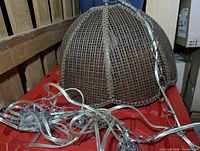 Full view of rattan tulip shade with chain and cord