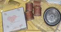 Boxed china rose napkin rings, four birch bark napkin rings, partial view of a coaster