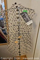 Front view of dress form showing wire mesh torso and adjustment knobs