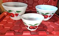 Three nesting Fire King Apples & Cherries milk glass bowls