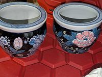 both porcelain planters side by side showing overall design and Greek key rim