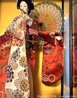 Close view of doll torso, kimono embroidery and parasol