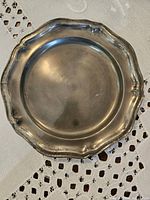 Scalloped-rim pewter wall plate top view