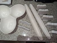 three-section dip bowl, two long narrow trays, five large and two small label stands on countertop