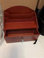 Front view showing slots, shelf and drawer