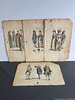 All four fashion plates laid out, showing overall size and condition