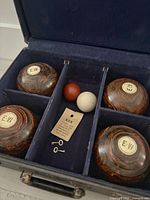 Open case showing four bowls, two jacks, key tag and keys