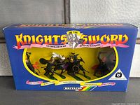Front view of sealed Britains Knights of the Sword box showing seven silver knights through window