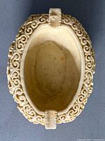 Top view showing oval shape, interior, and cigarette rests