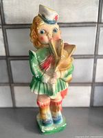 Front view of chalkware bagpiper showing overall form and paint wear