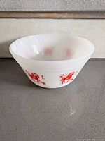 Side view of milk glass bowl showing red horse and rider graphic