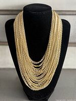 Front view showing full multi-strand drape on display bust