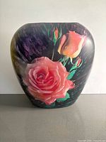 Front view of ceramic vase showing rose imagery