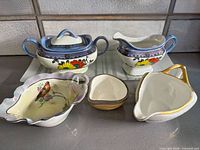 Five ceramic pieces: Japanese cream & sugar, Limoges gravy boat, Fitz & Floyd shell dish, ES Germany dish