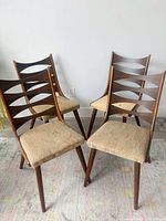 Front three-quarter view of all four chairs showing design and upholstery