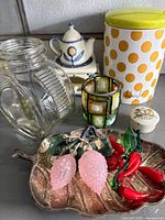 Group shot of all items including jar, oil lamp, candle holder, canister, leaf dish with glass fruit and Grafton box