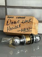 boxed chrome door knob lockset with keys and hardware