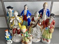 Group shot of all nine porcelain figurines