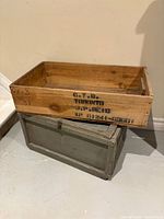 Light wood open-top crate resting on grey box