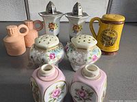 Group view of all nine shakers displaying varieties and condition