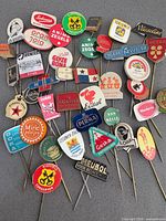Full group of assorted advertising stick pins spread out
