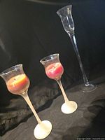 Full view of three glass candle holders showing relative heights