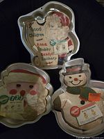 Three Wilton Christmas cake pans with inserts