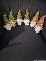 All six gnome figurines lined up for overview