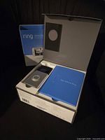 Opened box with doorbell, manual, accessories