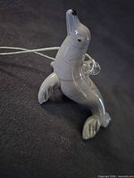 Left-front view of gray art glass seal ornament standing upright